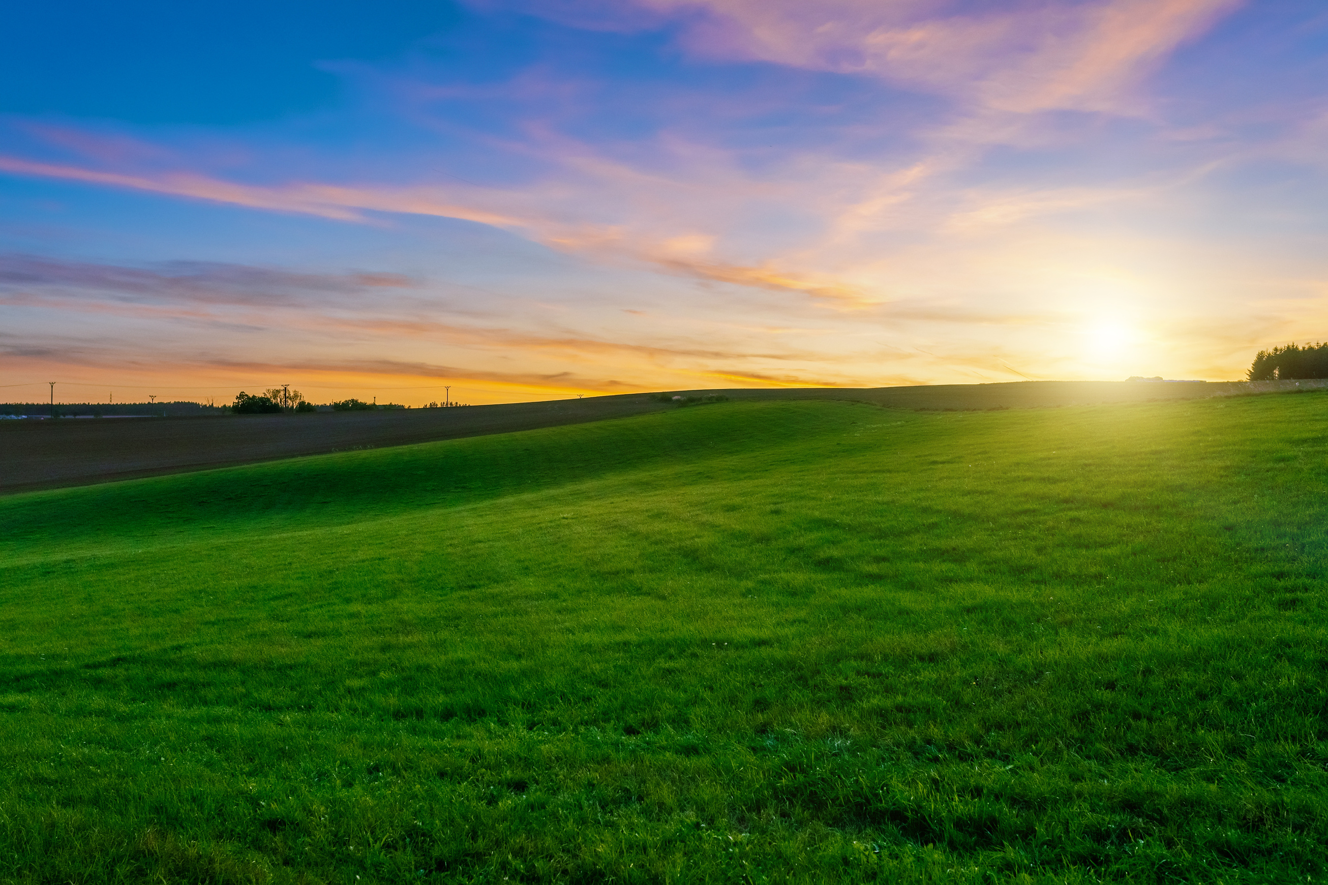 Sunset over Agricultural Green Field
